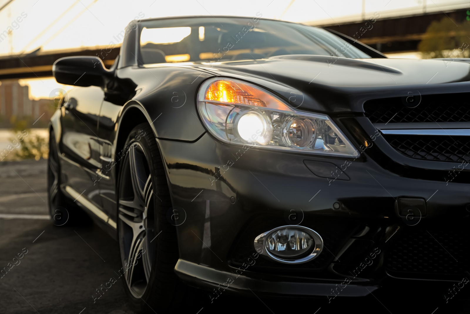 Photo of Luxury black convertible car outdoors, closeup view