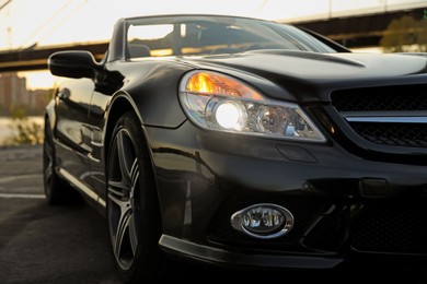 Photo of Luxury black convertible car outdoors, closeup view