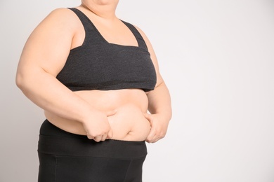 Photo of Overweight woman on light background