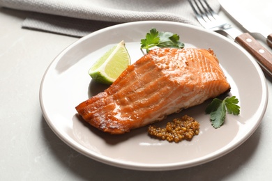 Photo of Tasty cooked salmon with mustard on plate, closeup