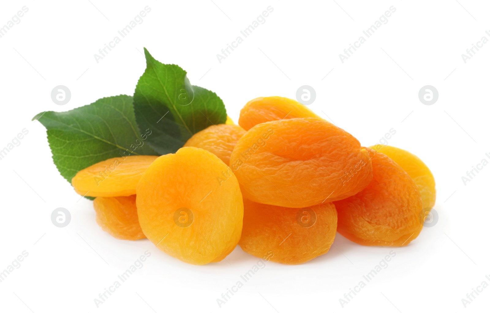 Photo of Pile of tasty apricots and green leaves on white background. Dried fruits