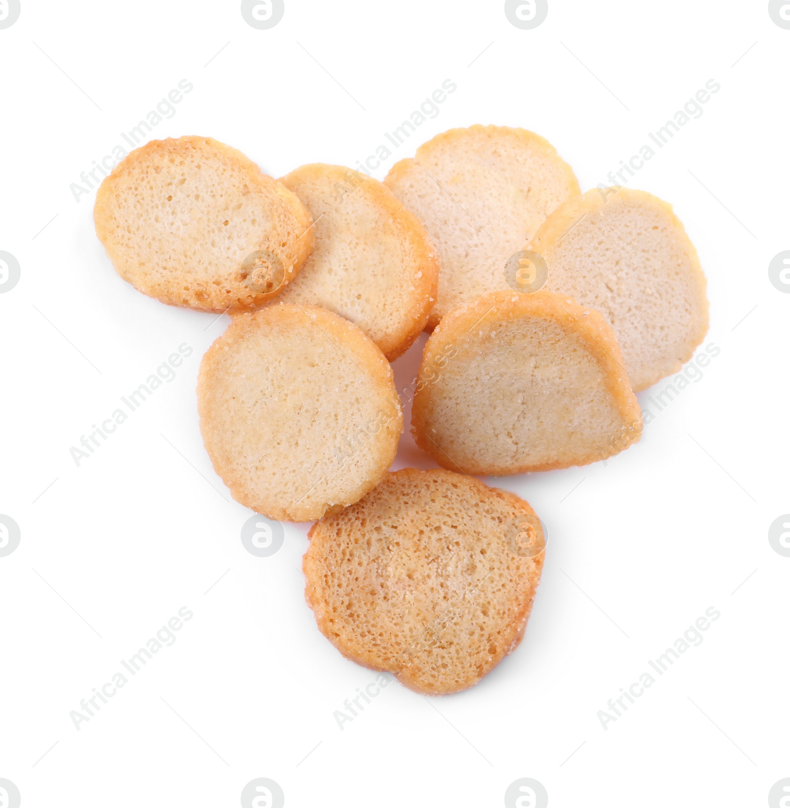 Photo of Pile of delicious crispy rusks on white background, top view