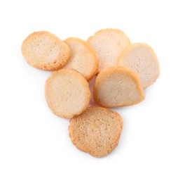 Pile of delicious crispy rusks on white background, top view