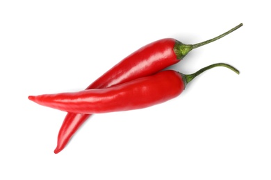 Photo of Ripe red hot chili peppers on white background, top view