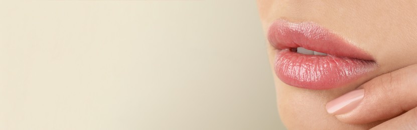 Image of Woman with beautiful lips on light grey background, closeup view with space for text. Banner design