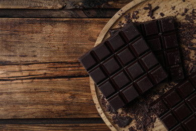 Tasty dark chocolate on wooden table, top view. Space for text