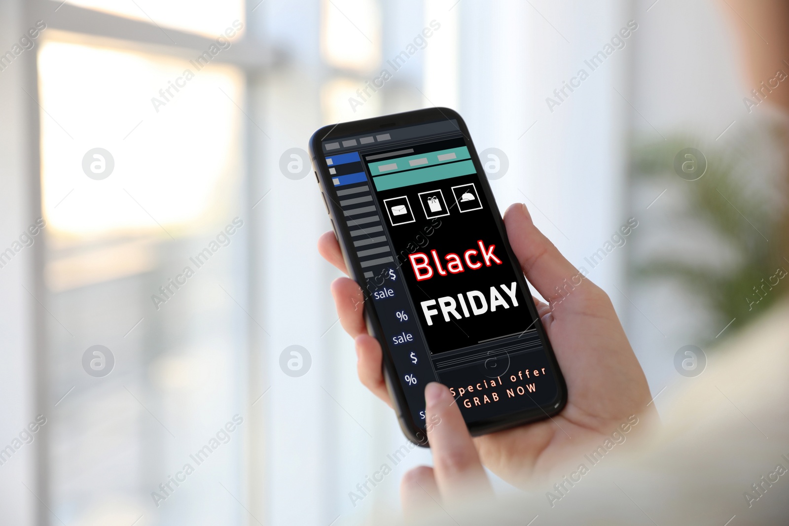 Image of Black Friday. Woman shopping online using smartphone, closeup