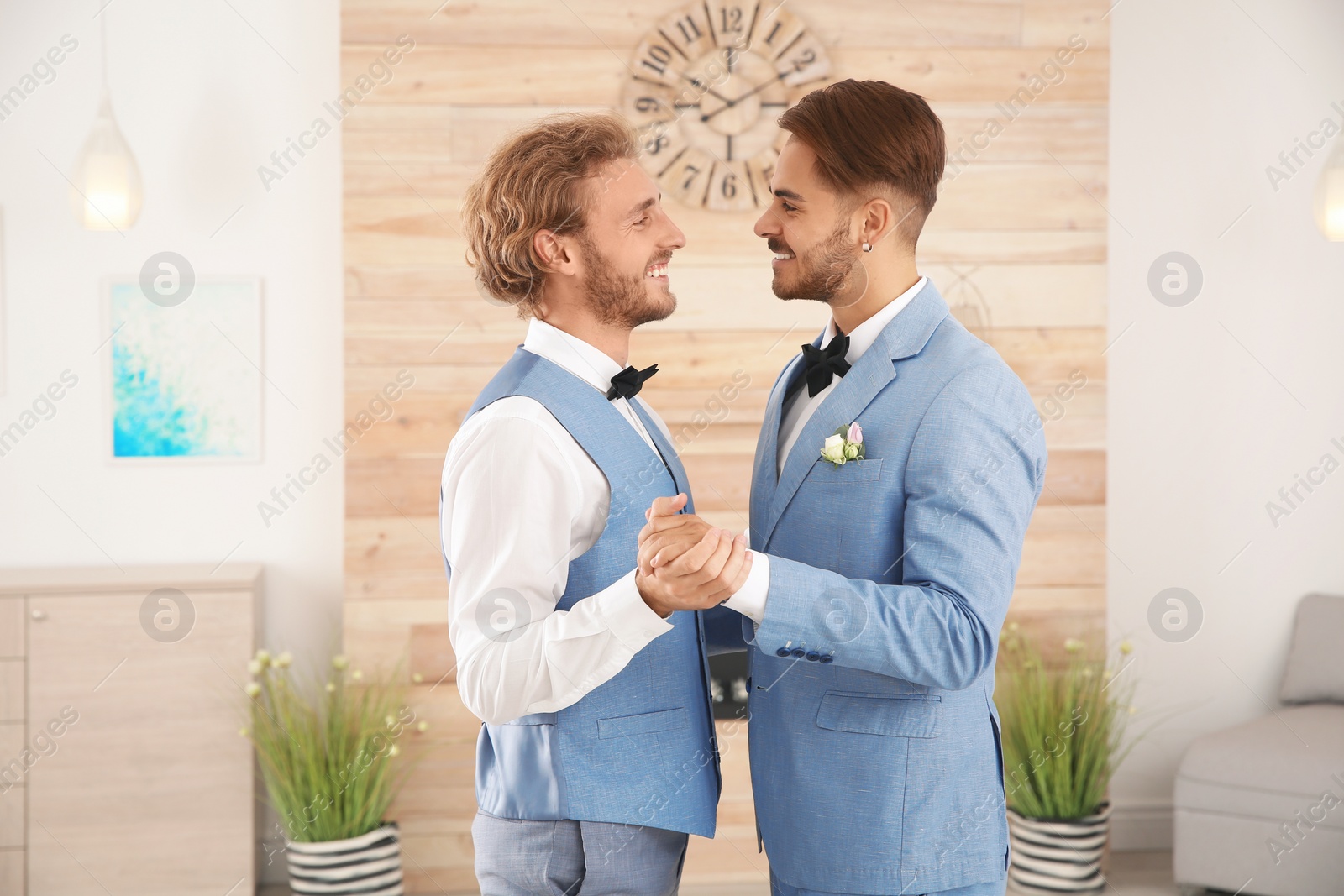 Photo of Happy newlywed gay couple dancing at home