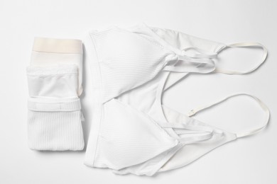 Photo of Stylish folded women's underwear on white background, flat lay
