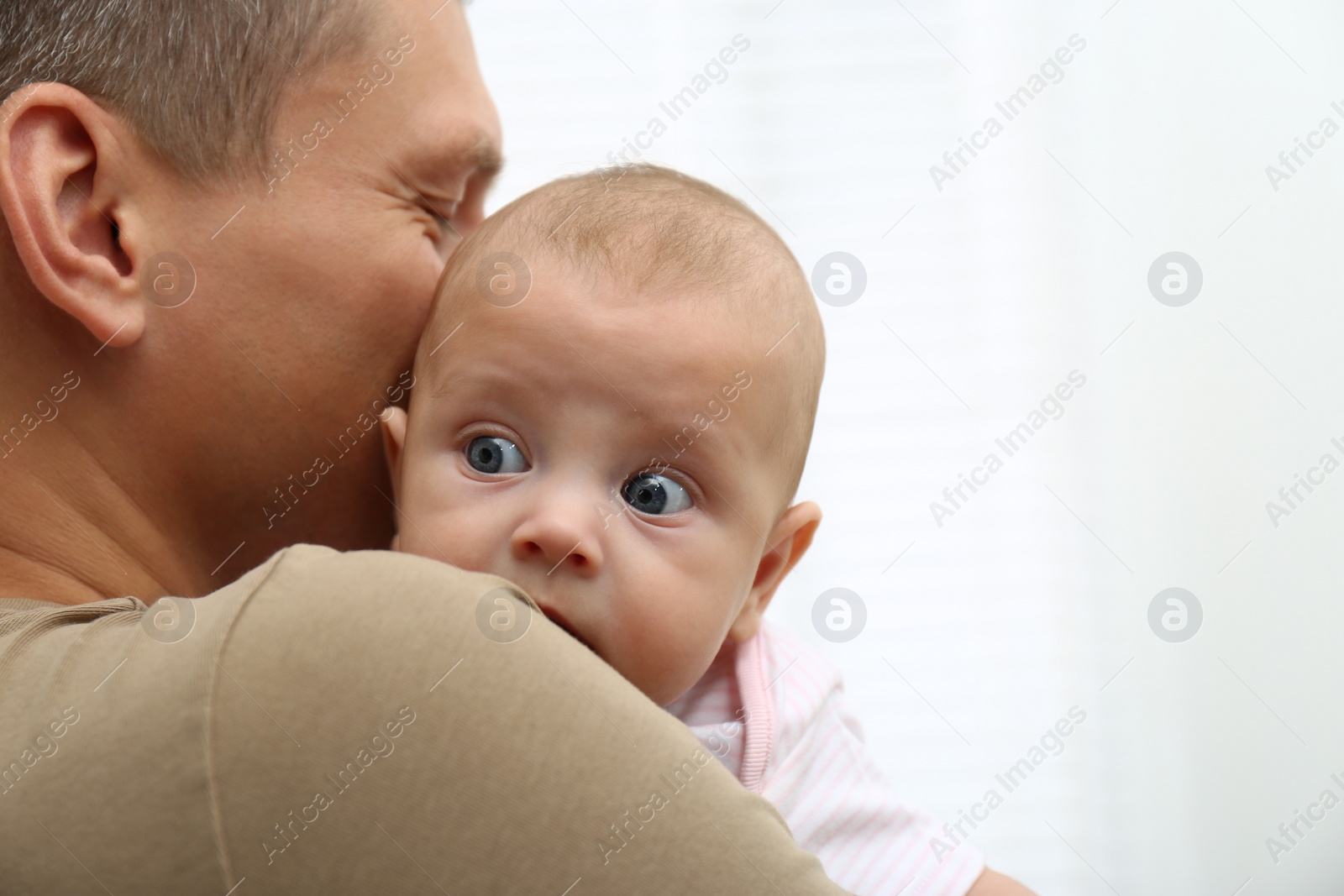 Photo of Father with his little baby on white background, closeup. Space for text