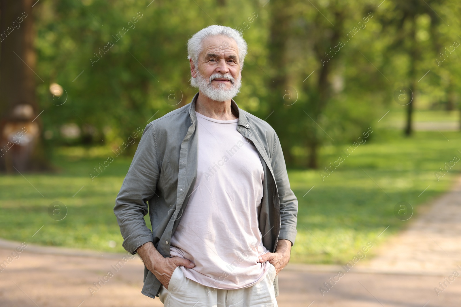 Photo of Portrait of happy grandpa in spring park