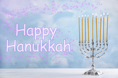 Image of Silver menorah on white wooden table. Happy Hanukkah!