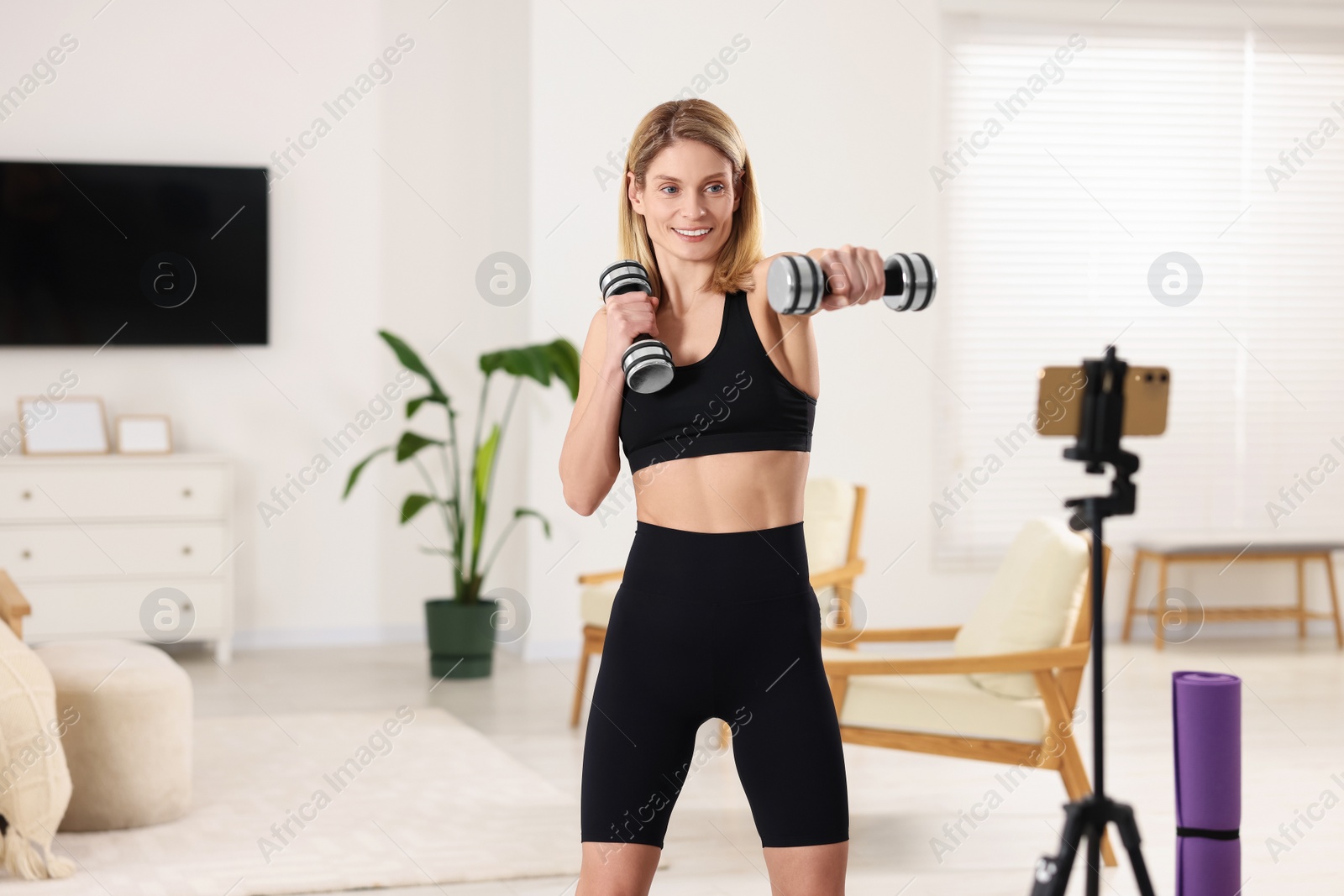 Photo of Fitness trainer recording online classes at home