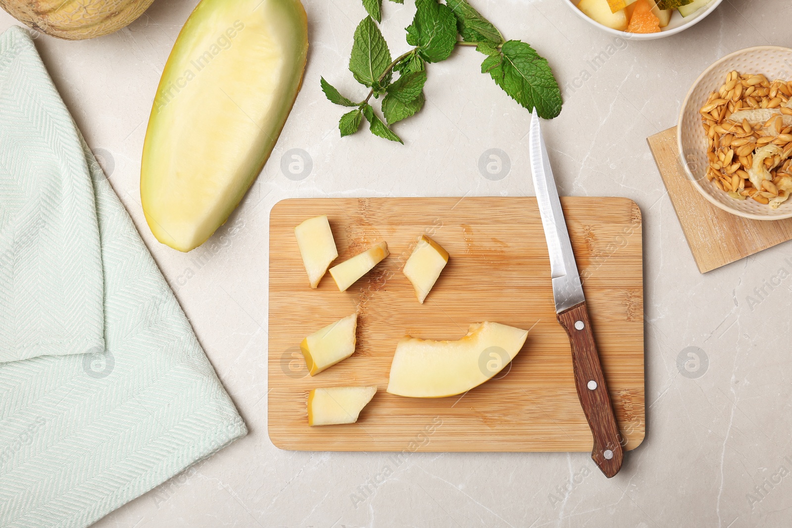 Photo of Flat lay composition with cut fresh tasty melons on table