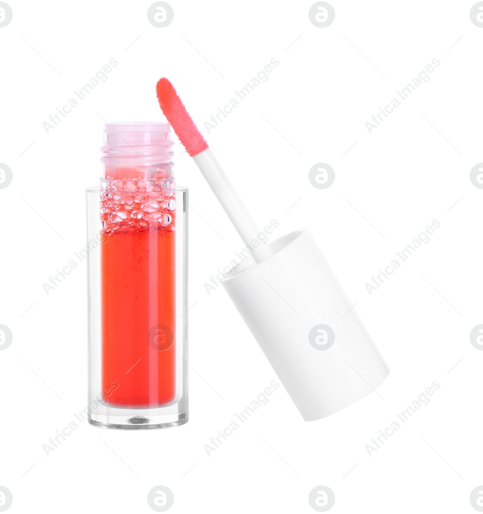 Photo of Bright lip gloss and applicator isolated on white. Cosmetic product