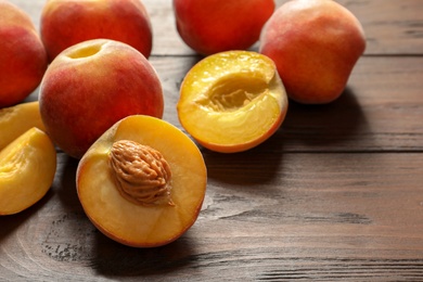 Fresh sweet peaches on wooden table, closeup