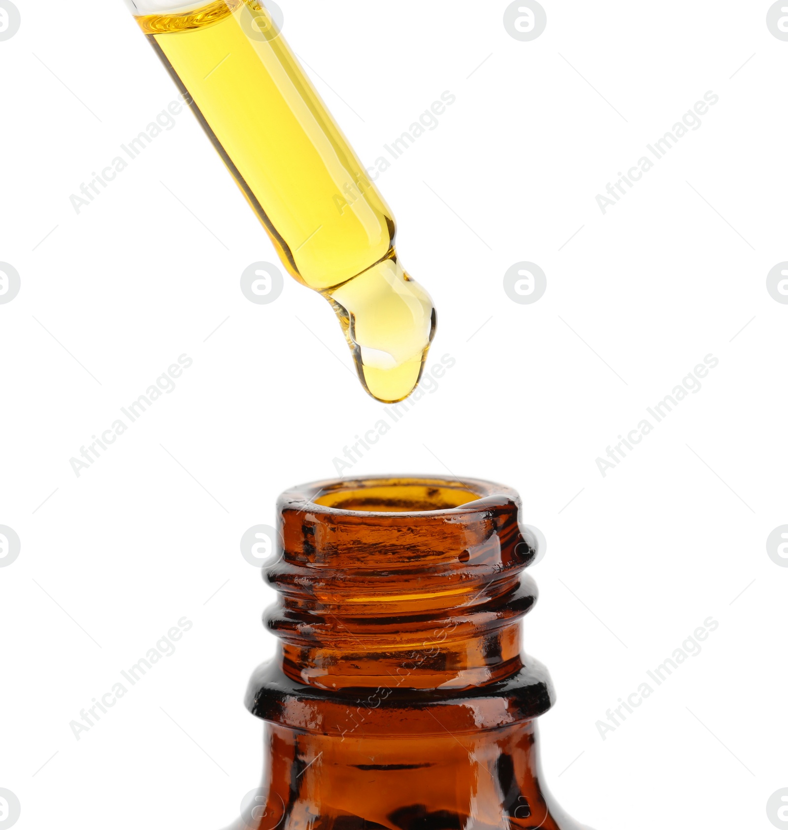 Photo of Dripping tincture from pipette into bottle isolated on white