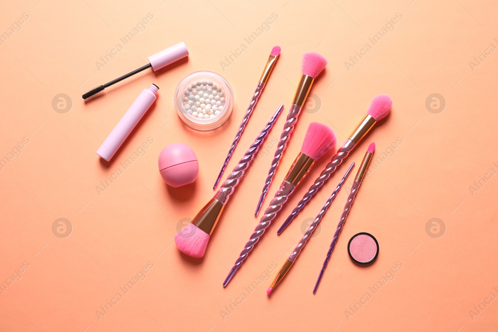 Photo of Flat lay composition with makeup brushes on orange background