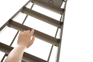 Photo of Woman climbing up stepladder against white background, closeup