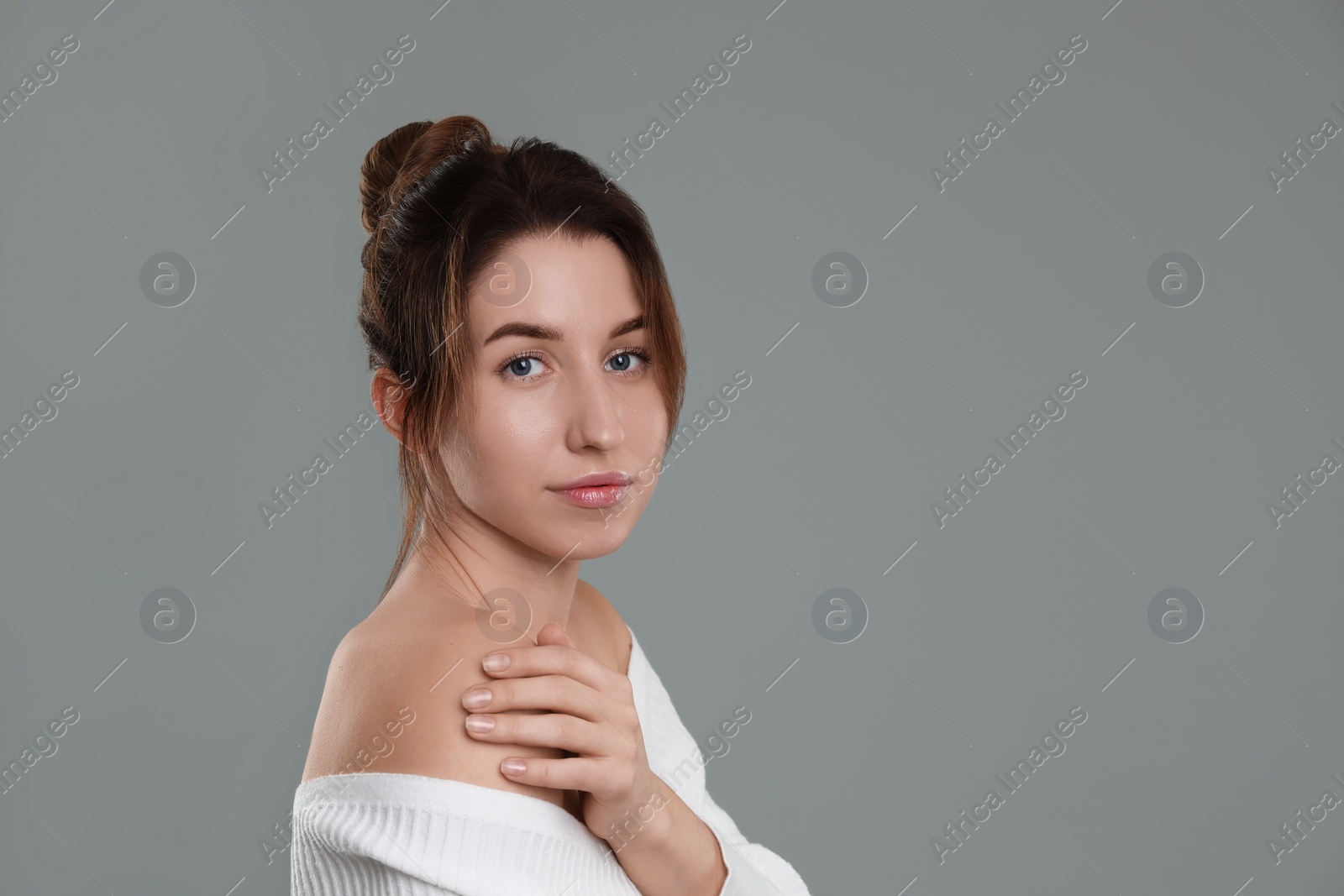 Photo of Portrait of beautiful young woman on grey background, space for text