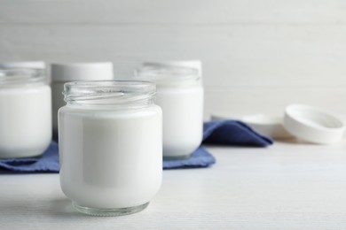 Tasty yogurt on white wooden table. Space for text