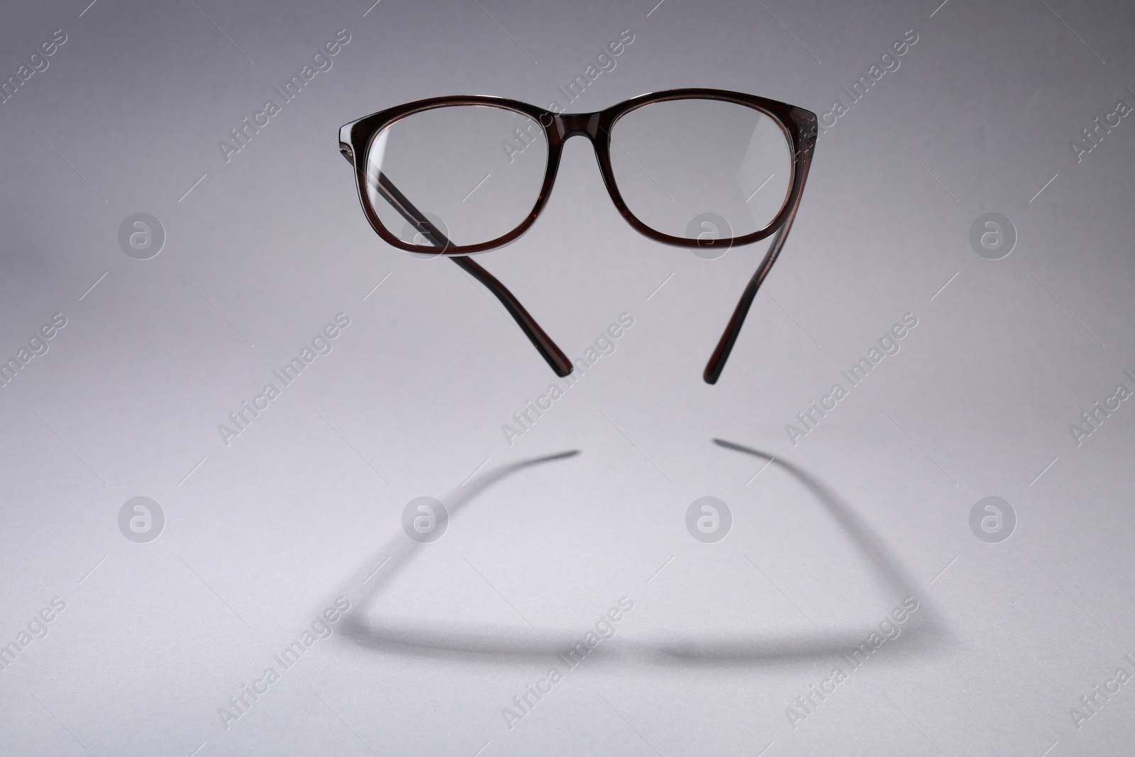 Photo of Stylish pair of glasses on light grey background