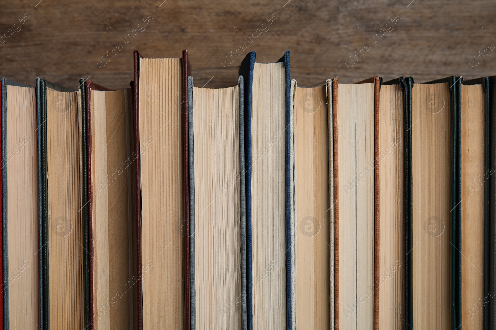 Photo of Stack of hardcover books on wooden background