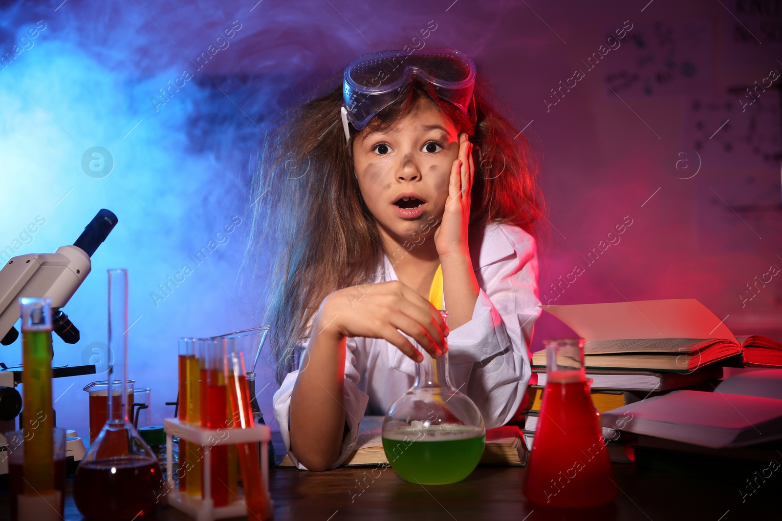 Photo of Child doing chemical research in laboratory. Dangerous experiment