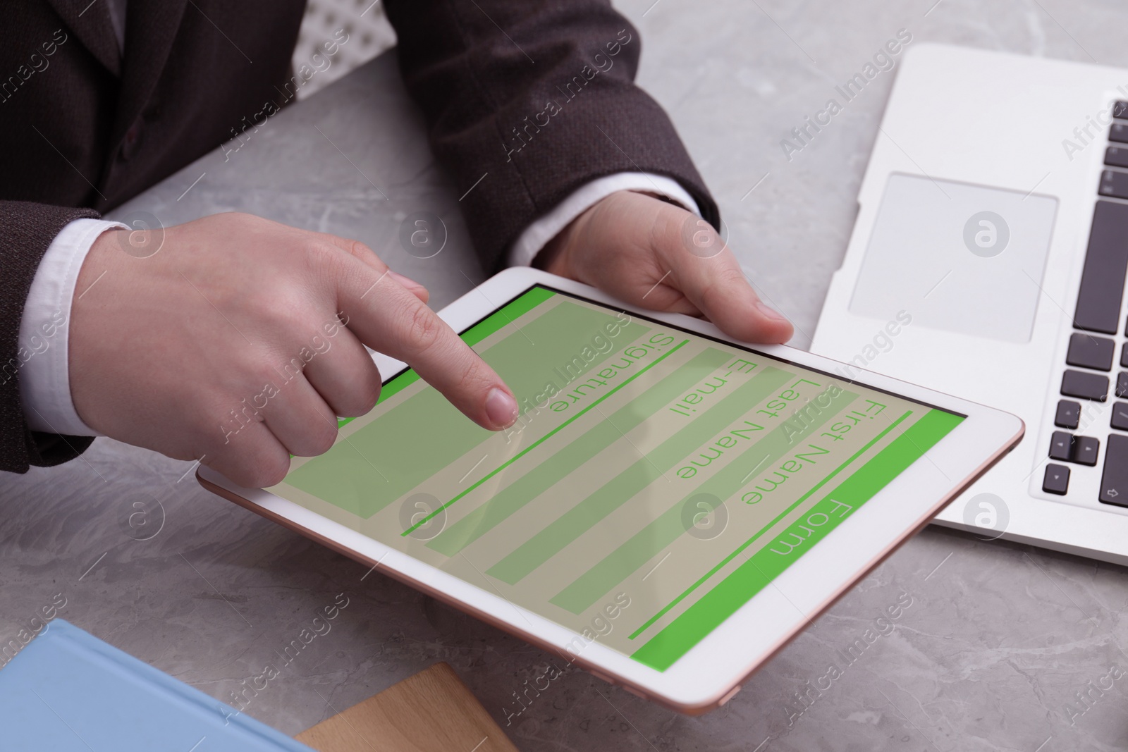 Image of Electronic signature. Man using tablet at table, closeup