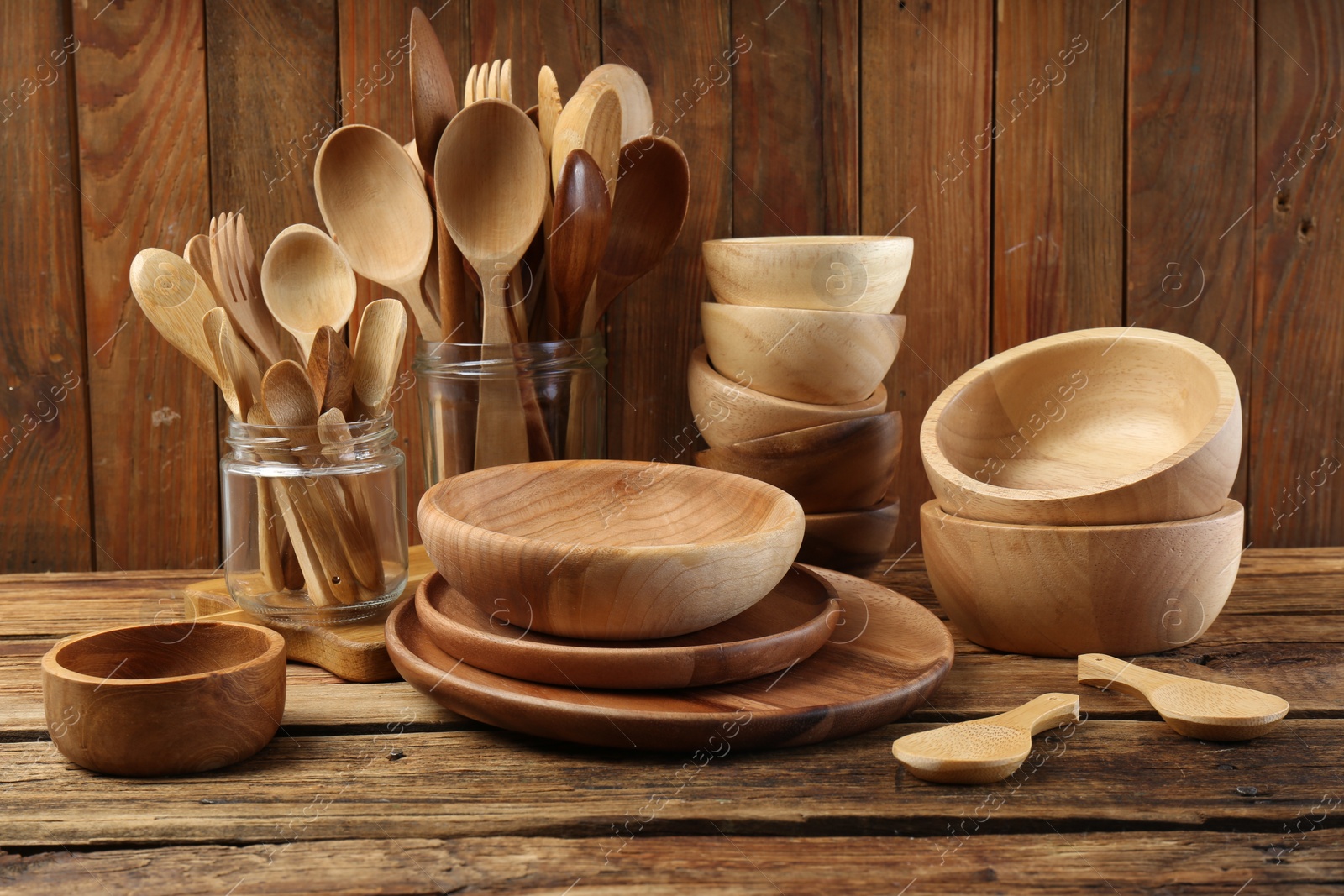 Photo of Many different wooden dishware and utensils on table