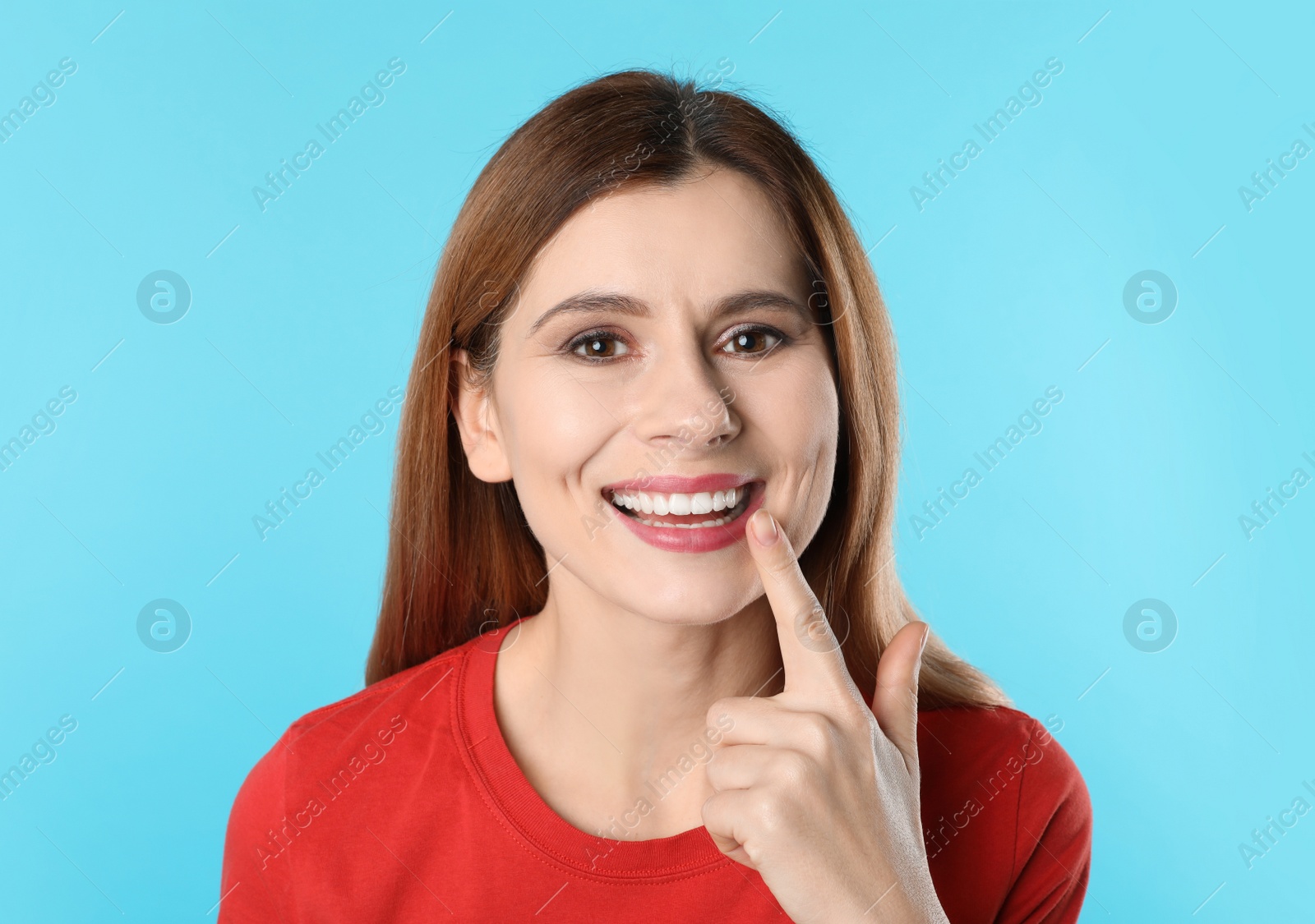 Photo of Smiling woman with perfect teeth on color background