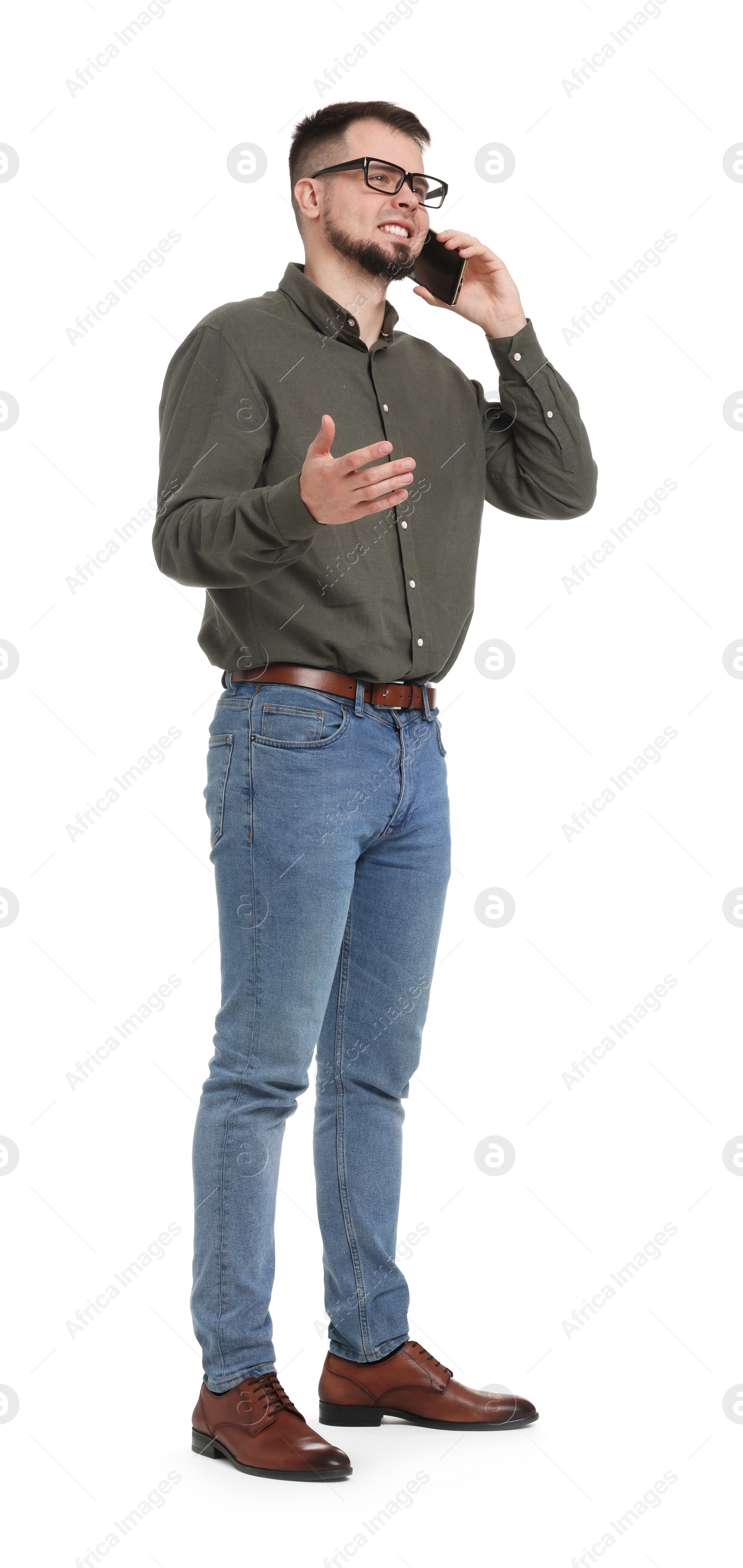 Photo of Man in shirt and jeans talking on phone on white background