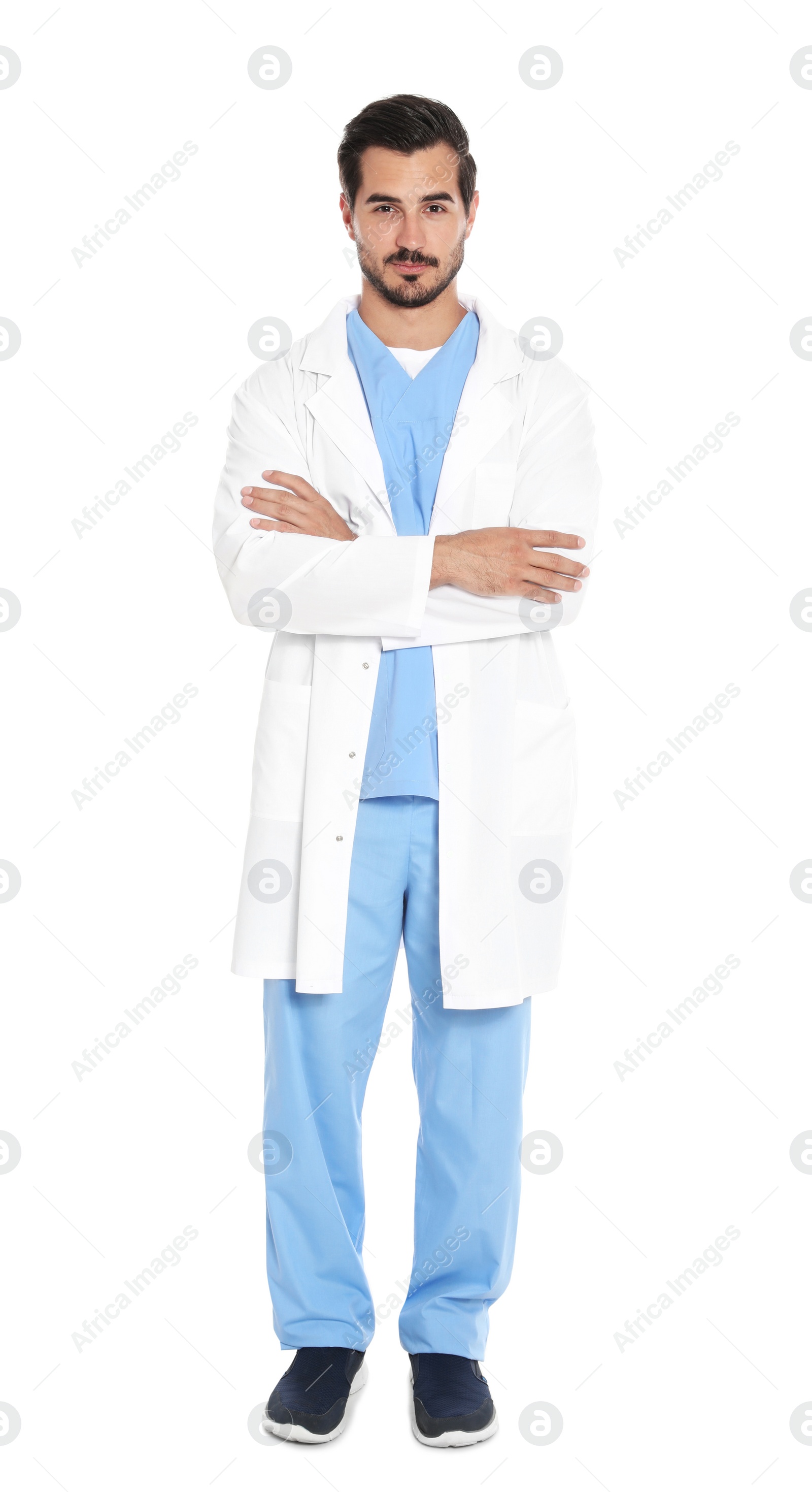 Photo of Young male doctor in uniform on white background. Medical service