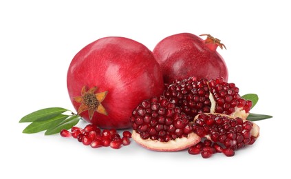 Photo of Tasty ripe pomegranates and leaves on white background