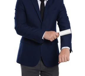 Man cleaning suit with lint roller on white background, closeup