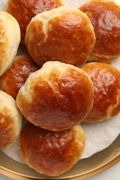 Plate with freshly baked soda water scones on table, top view