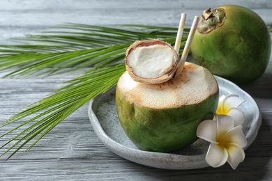 Fresh green coconut on wooden table