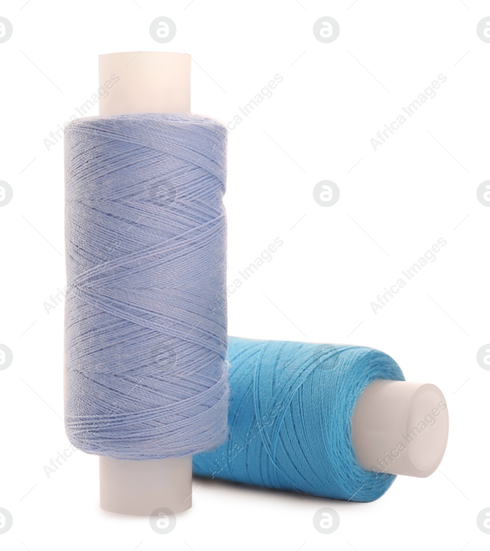 Photo of Different colorful sewing threads on white background