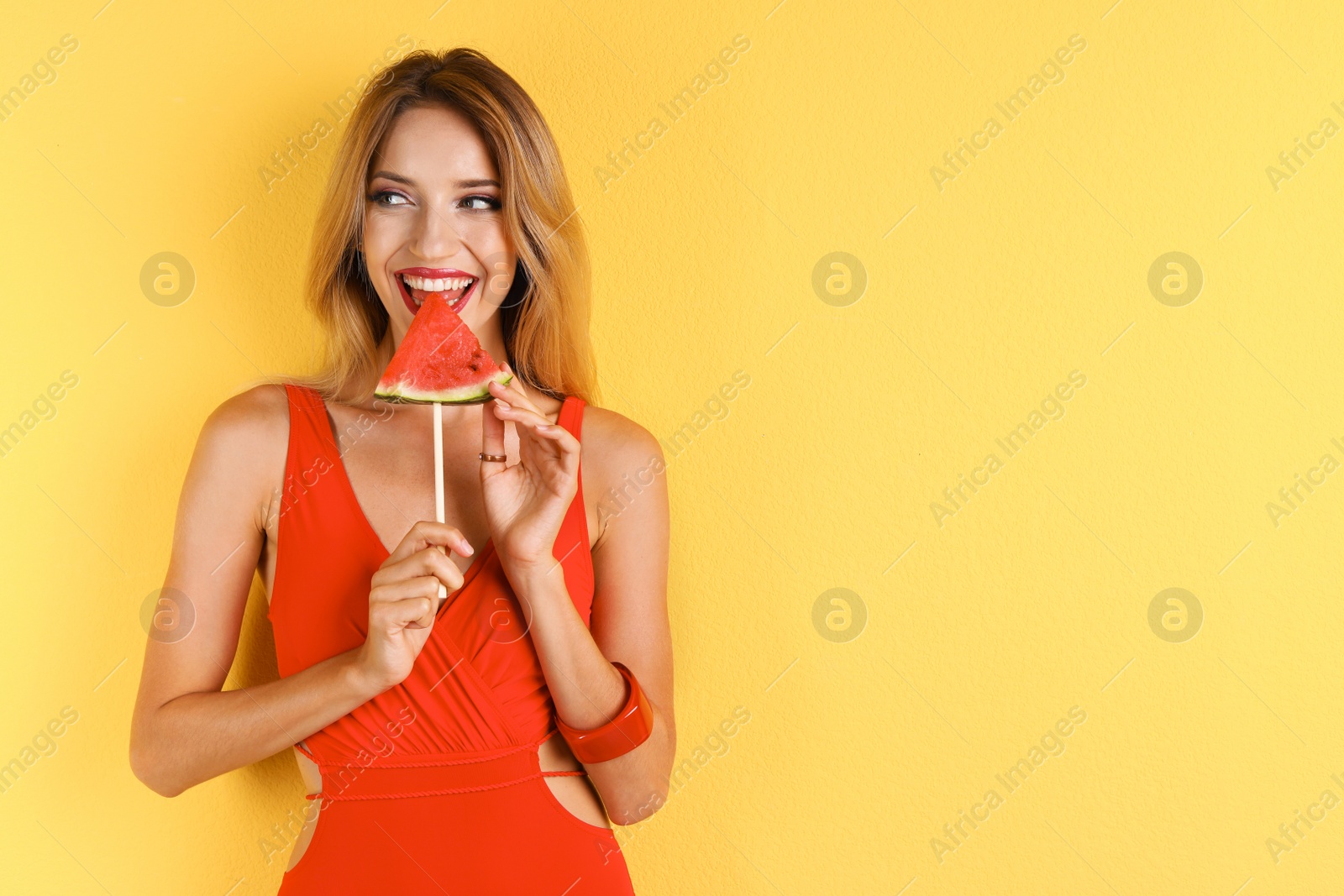 Photo of Pretty young woman with juicy watermelon on color background