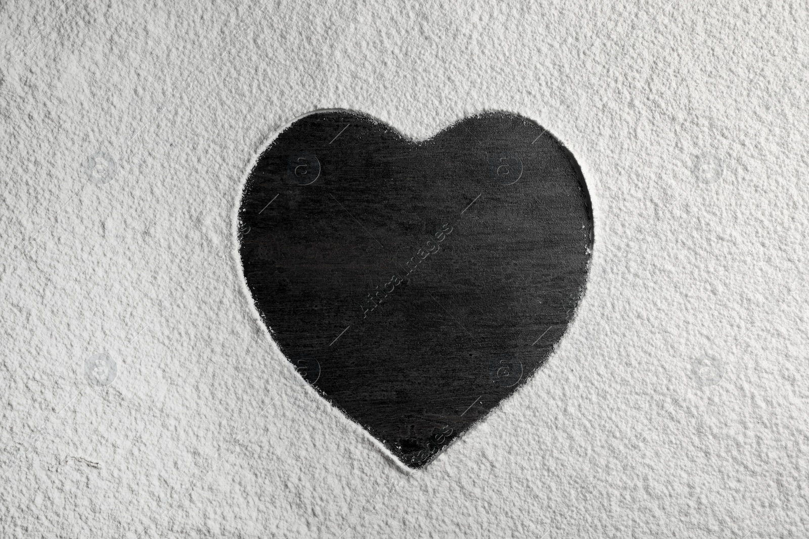 Photo of Heart-shaped frame made of flour on gray background, top view