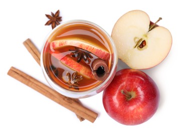 Photo of Hot mulled cider and ingredients on white background, top view