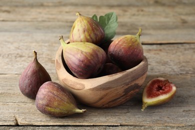 Photo of Many fresh ripe figs on wooden table