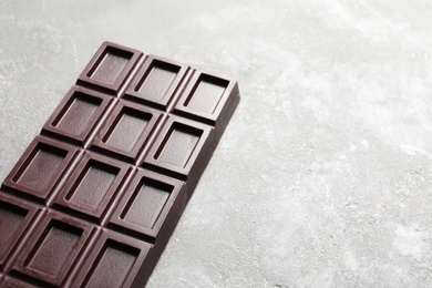 Chocolate bar on grey background. Space for text