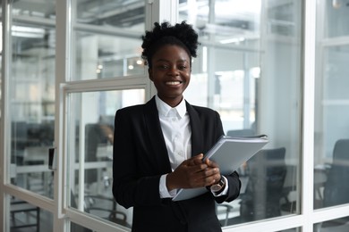 Photo of Happy woman with folders in office. Lawyer, businesswoman, accountant or manager