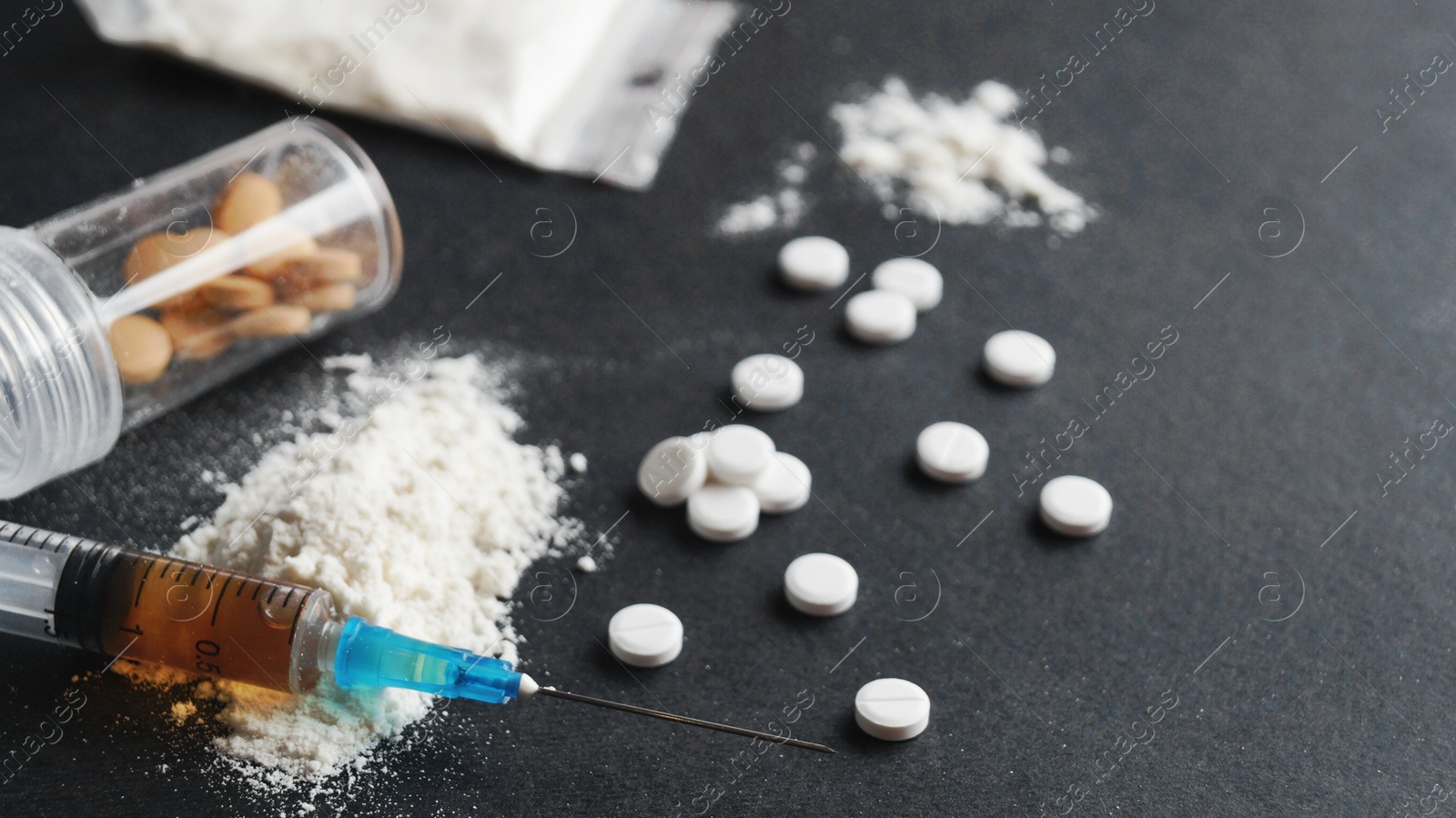 Photo of Different hard drugs on black background, closeup