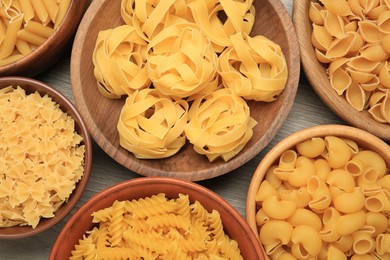Photo of Different types of pasta on table, flat lay