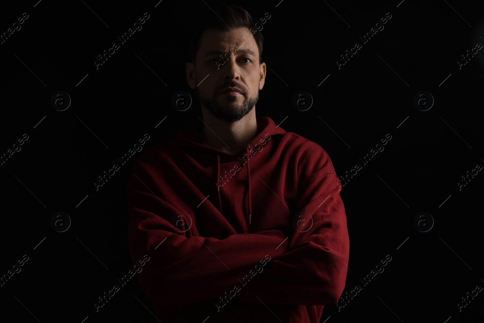 Photo of Portrait of handsome bearded man on black background