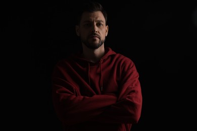 Photo of Portrait of handsome bearded man on black background