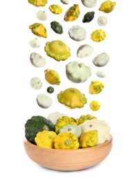 Fresh ripe pattypan squashes falling into bowl on white background 