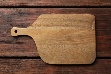 Photo of One new cutting board on wooden table, top view